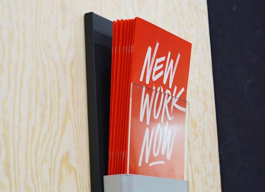 Rote Wandtafel mit dem Lettering „New Work Now“